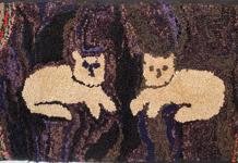 G207  19th century  Wool and cotton on burlap c. 1870-1890 Depicting  two white cats against an abstract ground with small rectangles as a border  19" x 39"