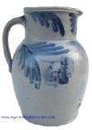 T421 Cobalt decorated stoneware pitcher, circa 1850 decorated with brushed cobalt flowers on front, the collar decorated with swag's on each side of spout.  measurements : 10 3/4"tall  5 3/4" diameter at bottom