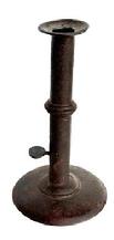 M117 Late 18th century Hog Scraper Wedding ring / band Candlestick with wide flat rim with finger curl at the top and working push-up tab bearing an illegible maker�s stamp. Sturdy sheet iron, hand forged construction with brass wedding band. Dark, natural surface. Circa 1790-1800. Measurements: 3 &frac12;� diameter base x 6 &frac14;� tall.