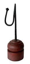 L236 Early 19th century hand forged iron tabletop rush light with counterweight arm to keep the rush grippers tight. Mounted in a turned wooden base with remnants of original red paint. Measurements: Base is 3 ¼ x 3 3/8 diameter x 3 5/8 tall. Overall height is 10 ¼ tall.