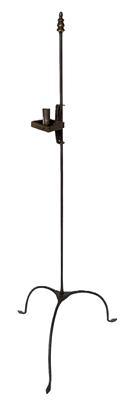 L162 Mid 18th Century hand forged wrought iron floor standing candlestand with brass finial and arched legs ending in arrow feet. This delicate candlestand boasts a single adjustable candle cup with a square drip pan. Approximate measurements: ~49 ½ tall. ~19 ½ across tips of feet. Candle socket is 2 1/8 tall and drop pan is ~3 square.