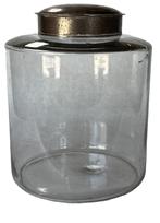 K232 Large, late 19th century Apothecary jar with tin lid. The jar is a hand-blown clear glass with remnants of the pontil on base. The glass is wavy with minor air bubbles and fine scratches in some places. Measurements:  8 diameter x 10 tall with lid.  