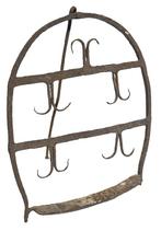 **SOLD** M1151 Great example of early wrought iron hearth ware with original surface and patina that dates from the mid to late 18th century, circa 1750-1780. Though this design is commonly referred to as a �Scottish Broiler�. The form is referenced in numerous volumes on period wrought iron, see �The Sorber Collection� by Don Plummer. Also, Wallace Nutting had referenced broilers of a similar nature as the design was carried over by immigrants and travels to America during the period. A broiler such as this was used at the foot of an open-hearth fireplace. A cut of meat, or a fowl would have been placed on the face of the broiler. The back standing leg would have allowed the piece to angle against the flames of the heat and allow for direct cooking. As you can see, this example carries a wonderful series of curled decorations that would not only function as a support but also absorb the radiant heat and allow for a more uniform cooking platform. Measurements: 14� wide x 16� tall. 