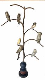 **SOLD** H469 American, 20th Century Folk Art Owl Tree, with seven different beautiful hand carved and polychrome painted wooden Owls resting on steamed and bent branches. Mounted in a colorful, multi-tiered turned base for display.  Signed, and branded on bottom, "Ken Kirby". This Owl tree stands 33 3/4" tall. It is 16 1/2� across at the widest branches. (Base measures 6" diameter x 8 ¼� tall)