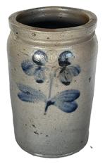 K1800 19th century Stoneware Jar  stamped I - boasting Cobalt Clover / Floral decoration typical of Peter Hermann of Baltimore, MD. Tall, cylindrical jar with lipped rim and tooled shoulder with a cobalt clover on both the front and back.  Good condition. Measurements: 6 top diameter x 6-6 ¼ bottom diameter x 10 tall. 