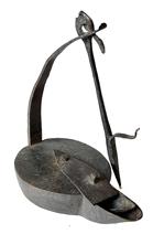 J369B Hand forged Iron hanging Betty Lamp / Whale / Fish Oil Lamp with sliding reservoir cover, iron spike hanger and internal wick support. Heavy. Fantastic surface with evidence of hand forging / filing. Approximate measurements: 10� tall with spike hanger. Purchased from a Delaware Estate. The oil/grease chamber measures approximately 2 ½� wide (back) x ½� wide (front) x 7/8� deep x 4� long