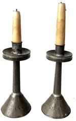 J398 Unique early pair of handmade tin candlesticks with punched decorations and conical shaped weighted bases.  Embossed diagonal lines adorn the center stems while punched decorations adorn the base and around the edge of the raised drip cups. Rolled edges with tight soldering joints throughout. From a Pennsylvania collection. (Candles not included) Measurements: 7� tall x 3� diameter (base)