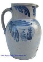 T421 Cobalt decorated stoneware pitcher, circa 1850 decorated with brushed cobalt flowers on front, the collar decorated with swags on each side of spout.  measurements : 10 3/4"tall  5 3/4" diameter at bottom