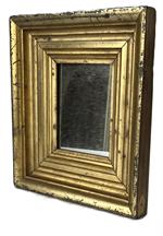 K1674 Small sized Pennsylvania wooden framed mirror boasting original gold gilded molded frame secured with tiny cut nails. Measurements: 9 ¼ wide x 10 ¼ tall x 1 ¾ deep.  