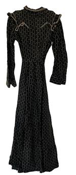 (i315) Late 19th century Womans black and white dress with lined bodice and pressed leather buttons. This dress features decorative ruffles and woven cotton trim typical of the period. Very nice condition. Circa 1880s-1910.  