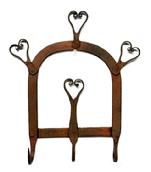 **SOLD** M203 Early hand-forged Iron hanging rack featuring handmade hearts and three hooks retaining remnants of early red painted surface. Measurements: 8 3/8 wide x ~1 ¾ deep (at hooks) x 9 ½ tall.