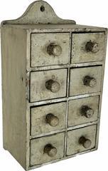 H134 19th century Pennsylvania hanging spice chest with eight drawers in old gray painted surface with original wooden knobs. Decorative cutout both top and bottom on back