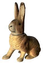 0 Easter Candy Container - Flocked Rabbit in crouched position with right paw stretched forward. Circa 1940 Brown color, flocked surface, made of composite material with removable head and glass eyes.