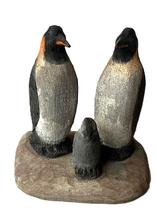 K1839 Hand carved and painted Folk Art Penguin Family  signed on bottom  Rick M. (illegible last name). Solid wood construction. Measurements: 3 7/8 wide x 2 ¾ deep x 3 ½ tall. 