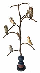 **SOLD** H470 American, 20th Century Folk Art Owl Tree, with seven different beautifully hand carved and polychrome painted wooden Owls resting on steamed and bent branches. Mounted in a colorful, multi-tiered turned base for display.  Signed, and branded on bottom, "Ken Kirby". This Owl tree stands 34 1/2" tall. It is 18 1/2� across at the widest branches. (Base measures 5" diameter x 8 1/2� tall) 