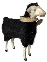 K78A German Putz Black Sheep - with bell and collar.  He has a black fur-covered composition body with freestanding wooden legs and painted hooves. Painted eyes and facial details. He stands approximately 3 ½ high and is 3 ¼ long.