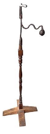 L227 Late 18th century to early 19th century hand forged wrought Iron Rush Light Holder on turned wooden floor stand. Unique design with scrolled top and heavy iron ball counterbalance on shaped arm. Exceptional surface patina. Approximate measurements: 46 ½ tall x ~9 deep at ball counterbalance x ~18 across feet.