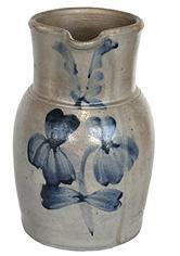 K113 Beautiful Baltimore, Maryland cobalt blue decorated stoneware crock pitcher marked Peter Hermann - 1 Gal Circa 1870. Decorated with brushed cobalt flowers on front and the collar is decorated with swags on each side of spout. Slight hairline crack at base of handle, otherwise in fantastic condition. Overall height: 10 ¼ tall.  