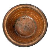 M212 18th century Pennsylvania Slip-Decorated Redware Bowl with lipped edge bearing beautiful deep reddish orange color with yellow slip decoration. The bottom is blackened from age and use. Visible hairline cracks and chips to interior surface. Measurements: 10 10 ¼ top diameter x 6 ½ bottom diameter x 3 ½-3 5/8 tall, depending on where measured.