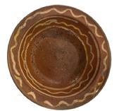**SOLD** M295 19th century Pennsylvania Slip-Decorated Redware Bowl with lipped edge bearing beautiful deep reddish orange color with yellow slip decoration. Wear commensurate with age. Measurements: 8 top diameter x 4 ¾ bottom diameter x 2 ¼ deep.