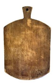 M127 Early 19th century wooden Peel Board / Cutting board with shaped handle and hole for hanging with scant remnants of its original mustard painted surface. Great patina, wear and chop marks are indicative of age and use. The wood is pine, one board construction with no cracks. Measurements: 30� long x 19� wide x 7/8� thick. 