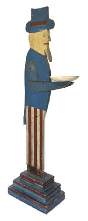 **SOLD** M161 Folk Art wooden Uncle Sam figure holding a small round hand carved bowl. Makers stamp on bottom reads Frank Smith Finney. Original red, white and blue painted surface. Measurements: ~14 deep x ~37 ½ tall. The bowl is 5 1/8 diameter. Base measures 6 5/8 wide x 10 5/8 deep. (NOTE: Royland Frank Smith Finney (b. 1947) from Cape Charles, Virginia is a well-known and highly sought after Southern Folk Artist.)