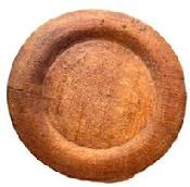 L512 Wooden plate with extensive wear on edges and "P" carved into the bottom of the slightly raised foot. Natural patina surface. Out of round. Measurements: 7 ¼ x 7" diameter x ~ ¼ - ~ ½ tall, depending on where measured.