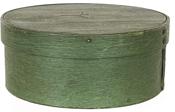 J200 New England 19th Century Pantry Box with original green painted surface featuring overlapping bentwood sides, secured with small metal tacks. The band is pegged on to the lid. A carving in the center of the lid depicts either initials or a symbol of some sort. Interior also bears original green painted surface. Measurements: 6 ½� diameter x 2 ¾� tall