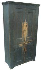 W205 19th century Pennslyvania four  door storage cupboard, original gray paint, all mortised and pegged construction,with molded panel doors,  with applied molding,cut out foot, the wood is white pine circa 1840 - 1850 