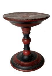 H1059 Early turned wooden pedestal / store display bearing black and red painted surface. Solid wood. Sturdy. Measurements: 8 ¾ tall. Out of round  top diameter is 7 ¼ x 7 1/8 round and the bottom diameter is 6 5/8 x 7 round