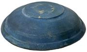 M1149 Early 19th century lathe turned wooden bowl with original old dark blue paint inside and outside featuring a lipped rim and slow turned lathe marks throughout � resting on a footed base with hand hewn center. Out of round. No cracks. Measurements: 6 5/8" x 7" top diameter x ~1 &frac12;� x ~1 5/8" deep, depending on where measured. Footed base is 3" x 3 &frac14;� diameter. 