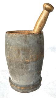 H954C 19th century wooden turned mortar and pestle in original, very dry, worn gray painted surface. Very simple turned design retains evidence of hand-hewn marks on the bottom. The pestle, which appears to be original to the mortar, has the original old patina surface and shows evidence of extensive use around the mashing end. Measurements: 5" top diameter x 4 ¾� bottom diameter x 7 ¾" tall. The Pestle measures 9 ½� long.