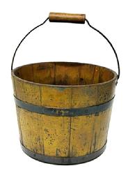 **SOLD** M179 Mid-19th century Shaker wooden bucket stamped �JK� on bottom. Bucket features iron diamond-shaped bail plates, wire bail with turned wood handle, chamfered bottom and tongue and grooved softwood staved sides secured with two iron bands bearing nice old yellow paint over original blue paint with great wear and patina on outside and natural patina interior. Measurements: 11 &frac14;� x 11 &frac34;� top diameter. 9 &frac12;� x 10� bottom diameter. 9� tall � not including handle. 