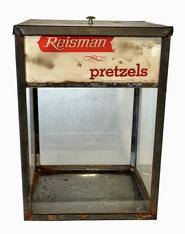 **SOLD** K1740 Early 20th century Pennsylvania store display advertising Reisman Pretzels. This glass and tin construction with encased lithograph advertising panels and original tin lid. This display was most likely used on a store counter or perhaps in a soda fountain. Circa 1920s-1930s. Very nice condition. Measurements: 6 5/8 square x 9 ¼ tall.   