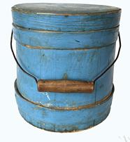 **SOLD** 19th century small original dry, robin-egg blue painted firkin with tapered sides and wire and turned wood bail handle. Tongue and grooved staved construction secured with a total of three single finger bands (two on bucket part, one on lid � secured with tiny square head nails) � the overlapping fingers are secured with copper tacks. The handle is secured with sheet iron round escutcheon plates. Dry painted exterior with great wear and a clean, natural patina interior.  Measurements: 7 ¼� top diameter x 8 1/8� bottom diameter x 7 ¾� tall (not including handle)  