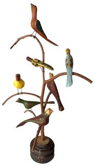 J212 Pennsylvania  signed and dated Daniel & Donna Strauser Folk Art Bird Tree  A Folk Art Carved Bird Tree by Dan Strawser 20th Century featuring seven carved and polychrome painted birds the underside is incised D+BS '77 height 21 1/2 inches