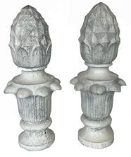 K9 Very early 20th century pair of matching solid cast iron Pineapple finials with geometric diamond shaped details on top with a series of detailed curved leaves below. Surface retains several layers of old white paint. Each finial is impressed with a marking that reads: 108 J. Hole inside the bottom for mounting purposes. Extremely heavy.  Circa 1900-1920s. Approximate measurements: 8 diameter (at widest point) x 5 ¾ diameter (at bottom)