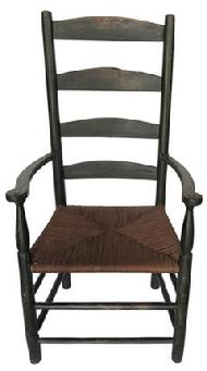 D25 Late 18th century Pennslyvania ladder back armchair with rush seat with Five arched slats enclosed by turned stiles.shaped arms with baluster and cylinder turned supports