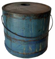 RM1340 Gorgeous original blue painted wooden Shaker bucket with hole for spout. Stave constructed with three metal bands. Retains working metal Bale handle with tin diamond escutcheons still intact.  Remnants of a stenciled merchant label from New Hampshire is visible on the top.  Second half-19th century. Measurements: 7 ¾� diameter (top) x 8 ¾� diameter (bottom) x 7 1/4" tall. 