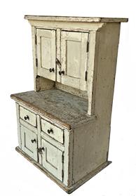 J385 Sweet Pennsylvania miniature child's stepback cupboard in the original oyster white painted surface. Cupboard boasts a total of four paneled fully functional doors and two working drawers. features beaded edging around all doors, drawers, top/waist/base molding and on the edges of interior shelves in the upper section. Tiny square head nail construction. Circa 1860s. Measurements: 13� wide x 8� deep x 19" tall