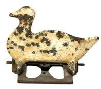 M1162 Figural cast iron Duck shaped knock-down Shooting Gallery Target bearing remnants of several layers of weathered white painted surface and original cotter pin and base. Remains in good working condition. Circa 1920s. Overall measurements: 7� wide x 4 5/8� deep x 6 3/8� tall.  