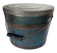 L397 Spectacular identified original blue painted lidded wooden bucket Stamped on bottom
.Made & Warranted, by JAMES WITCHER
. with arched wire bail handle and turned wooden grip. The thick, solid wood lid is rimmed by a ¾ tall metal band secured with hand forged tacks. The interior is old natural patina. Tongue and grooved staved construction held in place with ¾ tall metal bands secured with hand forged tacks. Measurements: 11 ¾ 12 top diameter x 10 ¼ bottom diameter x 9 ¼ tall.