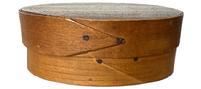 L468A 19th century Shaker miniature opposing finger lap oval pantry box with H. V. Baker stenciled in black on the bottom, and inside the lid. Natural patina surface throughout. Partially indistinguishable handwriting in pencil on the top of lid indicates this box held seeds in 1918. Exceptionally fine, delicate steamed and bentwood construction with top and bottom being secured with tiny wooden pegs and overlapping fingers secured with tiny tacks. Diminutive oval measurements: 4 3/8 wide x 3 deep x 1 5/8 tall.