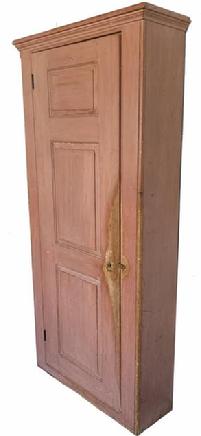 G545 Early 19th century outstanding New England Pantry Cupboard being 37" wide ,tall one door storage pantry / cupboard in original dry salmon paint. The door features three graduated raised panels with molded edges and beaded edge around the outer edge of the door. Beaded edge on both front corners. Original molding around the top. Seven shelves inside can be repositioned to accommodate any collection of items. Fantastic wear, especially on the door, that indicative of age and years of use. Circa 1800- 1820 