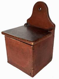 B637 Early 19th century Pennsylvania Salt Box with the original red paint. Dovetailed case featuring an arched back with hole for hanging. The wood is walnut. Circa 1820.