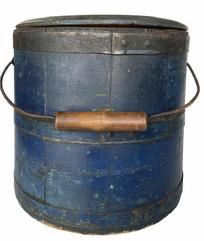 G579 Mid 19th century Shaker original blue painted, lidded wooden sugar bucket featuring iron diamond-shaped bail plates, wire bail with turned wood handle, chamfered bottom and tongue and grooved softwood staved sides secured with three iron bands. Fantastic dark blue paint with great wear and patina on outside and natural patina interior.