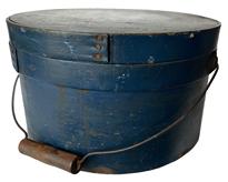 RM1077 19th century  New England bail handle pantry box, The box retains the original lid and bail handle. Everything is sturdy and stable.The original beautiful blue paint  Measurements: 11 1/4" diameter x 6 1/2" tall