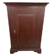 L537 Early 19th century one door cupboard with original painted surface, dovetailed case and beautiful, fully mortised raised panel door that retains its working lock with key. Applied molding surrounds the top and cupboard rests on applied bracket base with cut out feet. Clean, natural patina interior with sturdy shelves for storage. The wood is pine with square head nail construction.