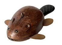 J343 Folk Art hand-carved wooden fishing decoy depicting a small Beaver. Solid wooden body with tin front/back legs. Detailed shaping to the body, tail, head, and ears. Very realistic carved details on the tail, original painted surface and glass inset eyes. Metal weight embedded in the underbelly. From a Wappinger Falls, NY collection.  Approximate measurements: 4 7/8� long x 2 ½� wide x 1 ¼� tall
