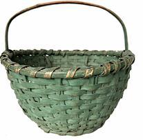 H379 Early 20th century Ohio painted basket. Woven splint with steamed and bent bentwood handle and original green paint. The rim of the Basket is single wrapped, the asket is resting on an applied base with a reinforced bottom